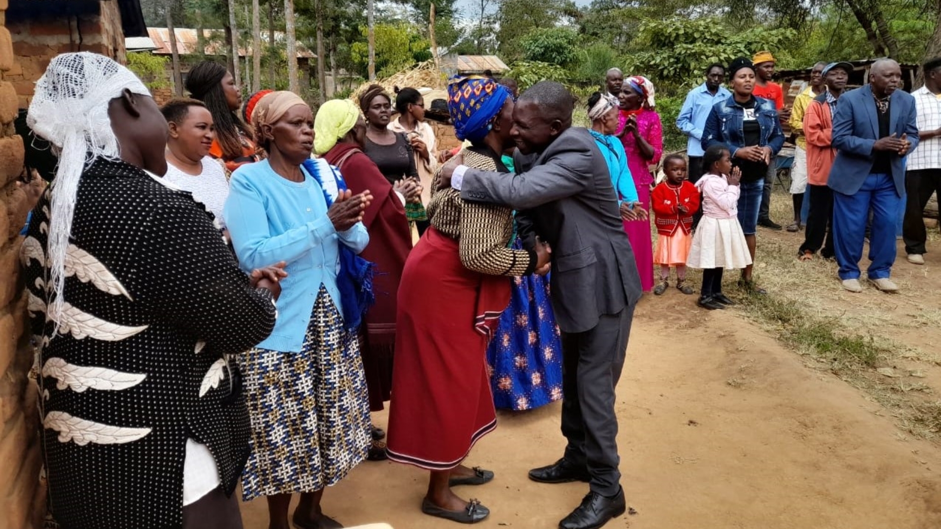 Mutunga is welcomed by family members after his arrival at home